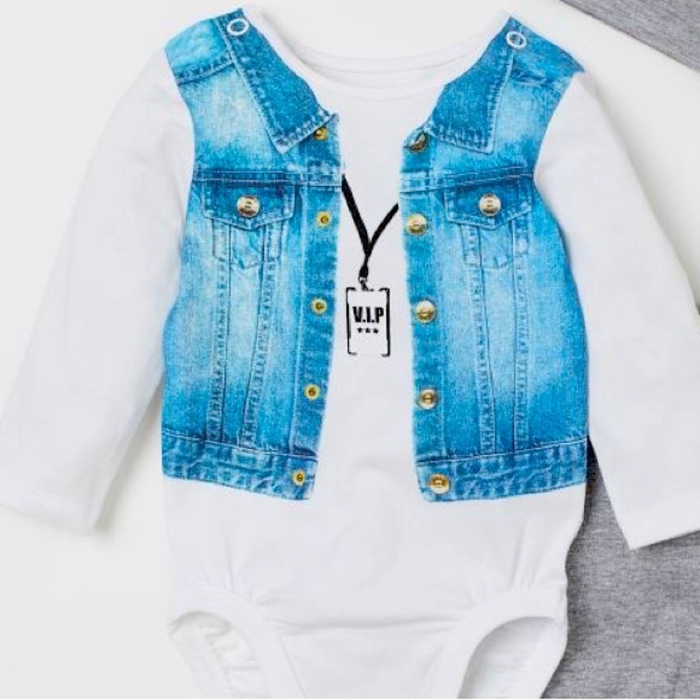 Bodysuit with a printed design at front and snap fasteners at gusset.